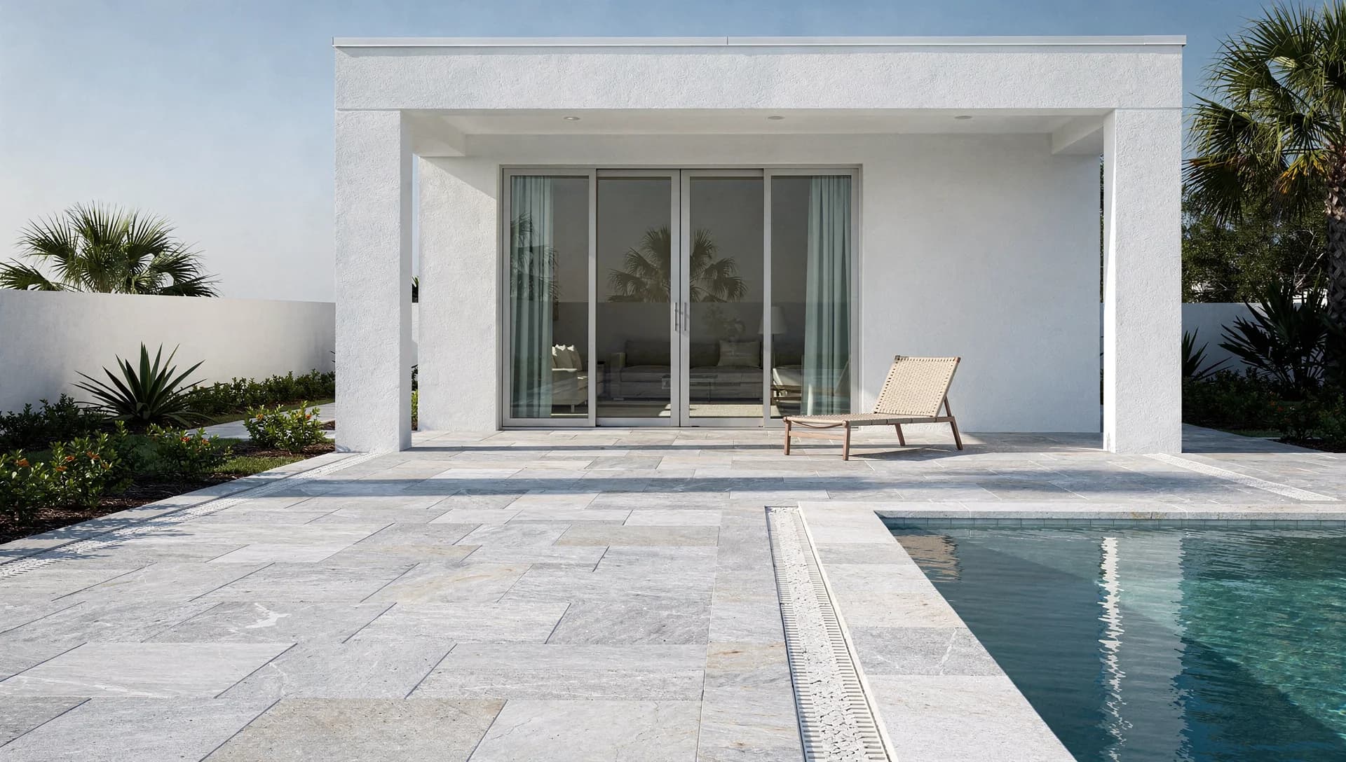 Pale gray stone poolside terrace and coastal pavilion