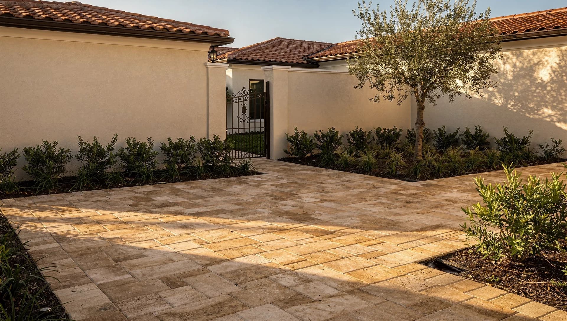 Warm sand-colored paving in a Mediterranean-style courtyard