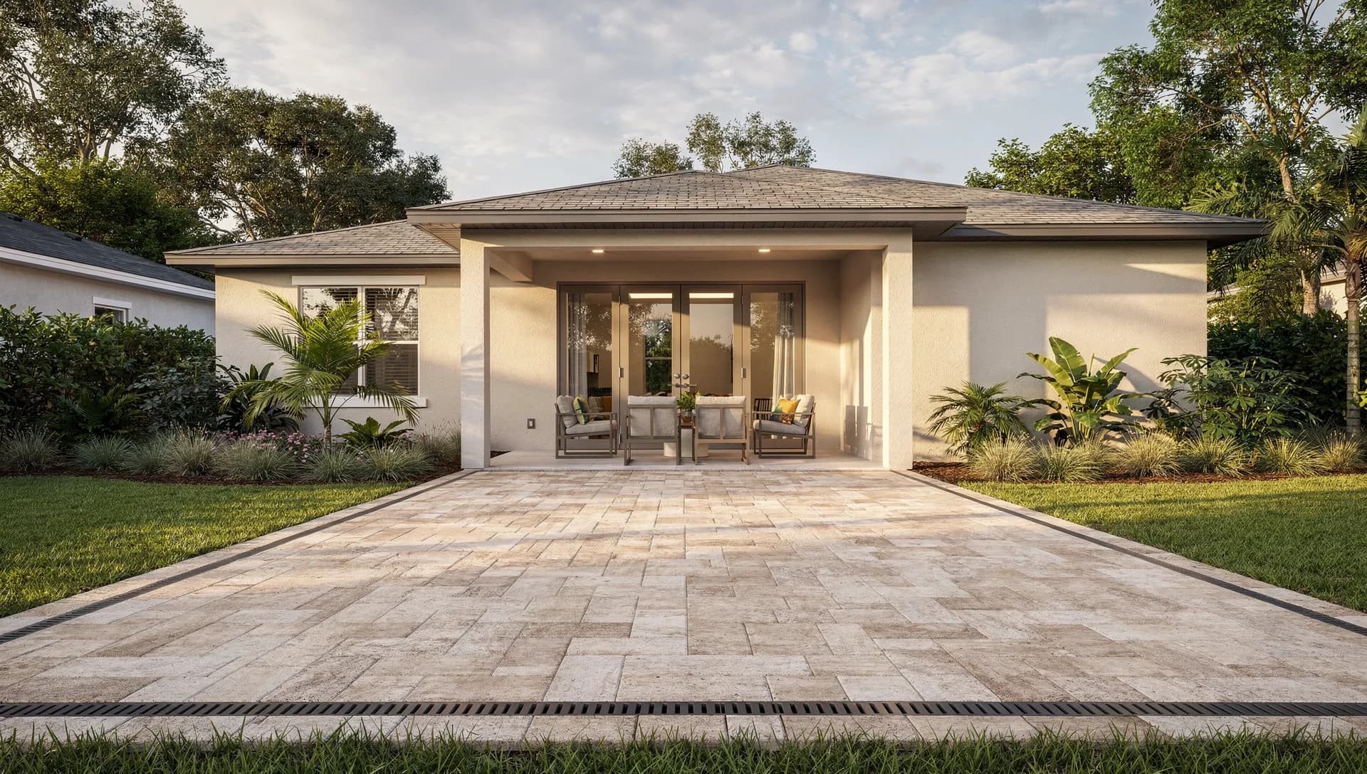Neutral paved Florida patio opening onto a landscaped lawn