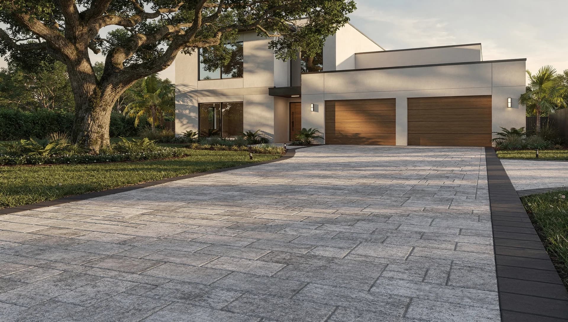 Gray modular paver driveway framed by a charcoal border