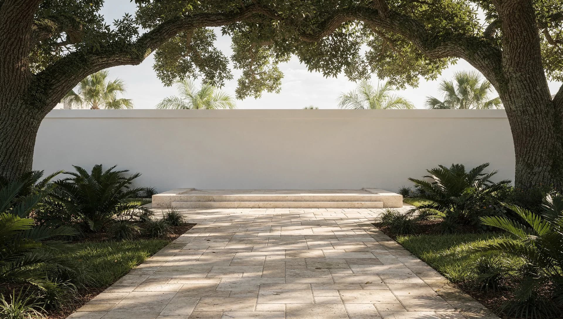 Light stone garden terrace beneath a live oak canopy
