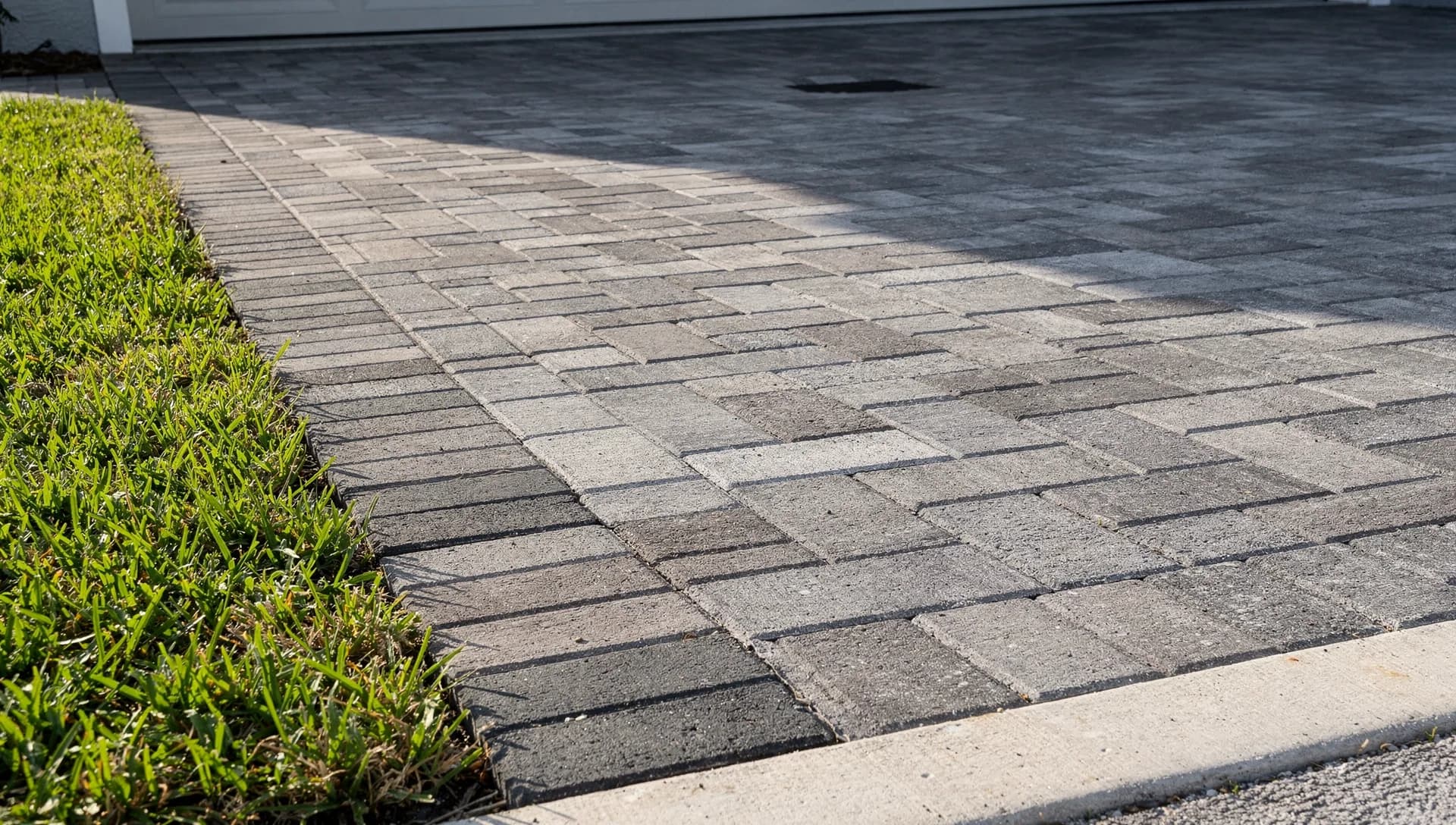 Gray paver pattern meeting a straight charcoal border